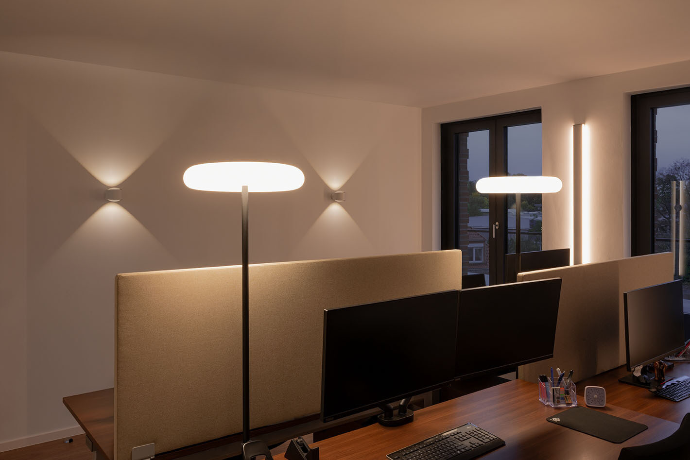 Das Büro wird von zwei p.133 Wandleuchten von prediger.base beleuchtet. Vertikale LED-Wandprofile von Sigor sowie zwei Oto Standleuchten von Belux sorgen für die Allgemeinbeleuchtung.