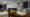 Ein Wohn- und Esszimmer in einem Hamburger Einfamilienhaus: Der Esstisch im Vordergrund wird von einer länglichen Pendelleuchte beleuchtet. Im Hintergrund sorgt eine runde Deckenleuchte im Wohnzimmer für die Allgemeinbeleuchtung. (Foto: Prediger Lichtberater) imageThumbnailAlt